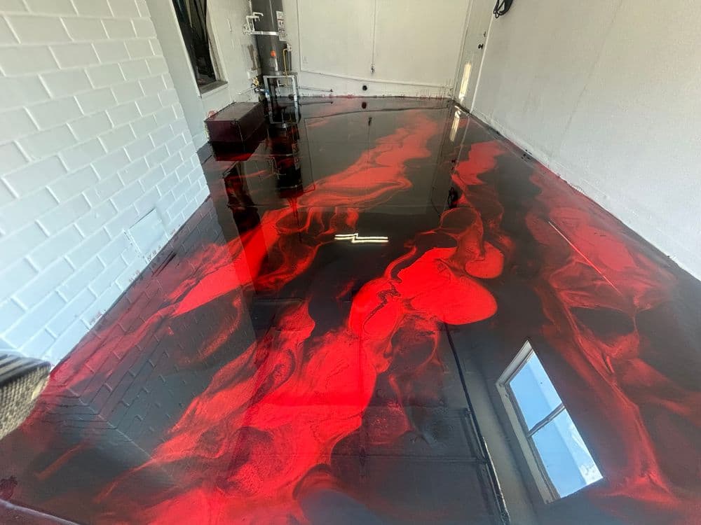 Glossy red and black epoxy flooring in modern industrial interior space.