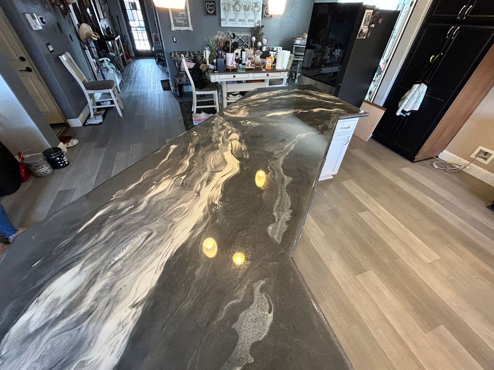Stunning kitchen countertop with a marbled design and modern decor in the background.