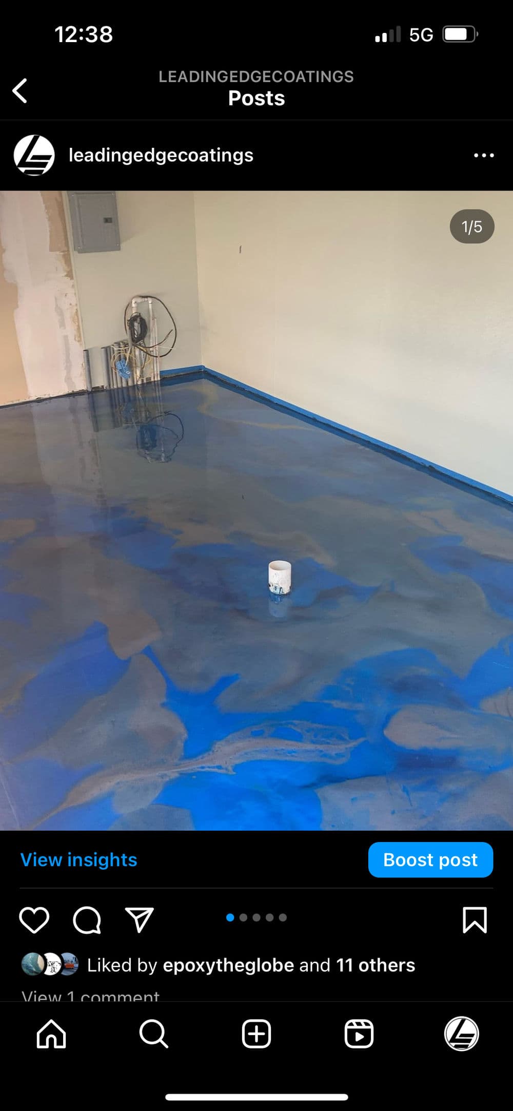 Epoxy-coated floor with blue finish and paint can in a newly renovated space.
