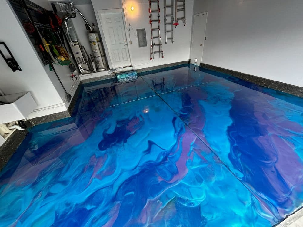 Epoxy-coated garage floor with swirling blue and purple patterns, showcasing a modern look.
